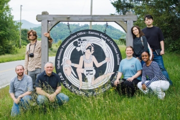 W&M Anthropology students pose in front of a sign marking the entrance to the Eastern Band of Cherokee Indian's Tribal Office